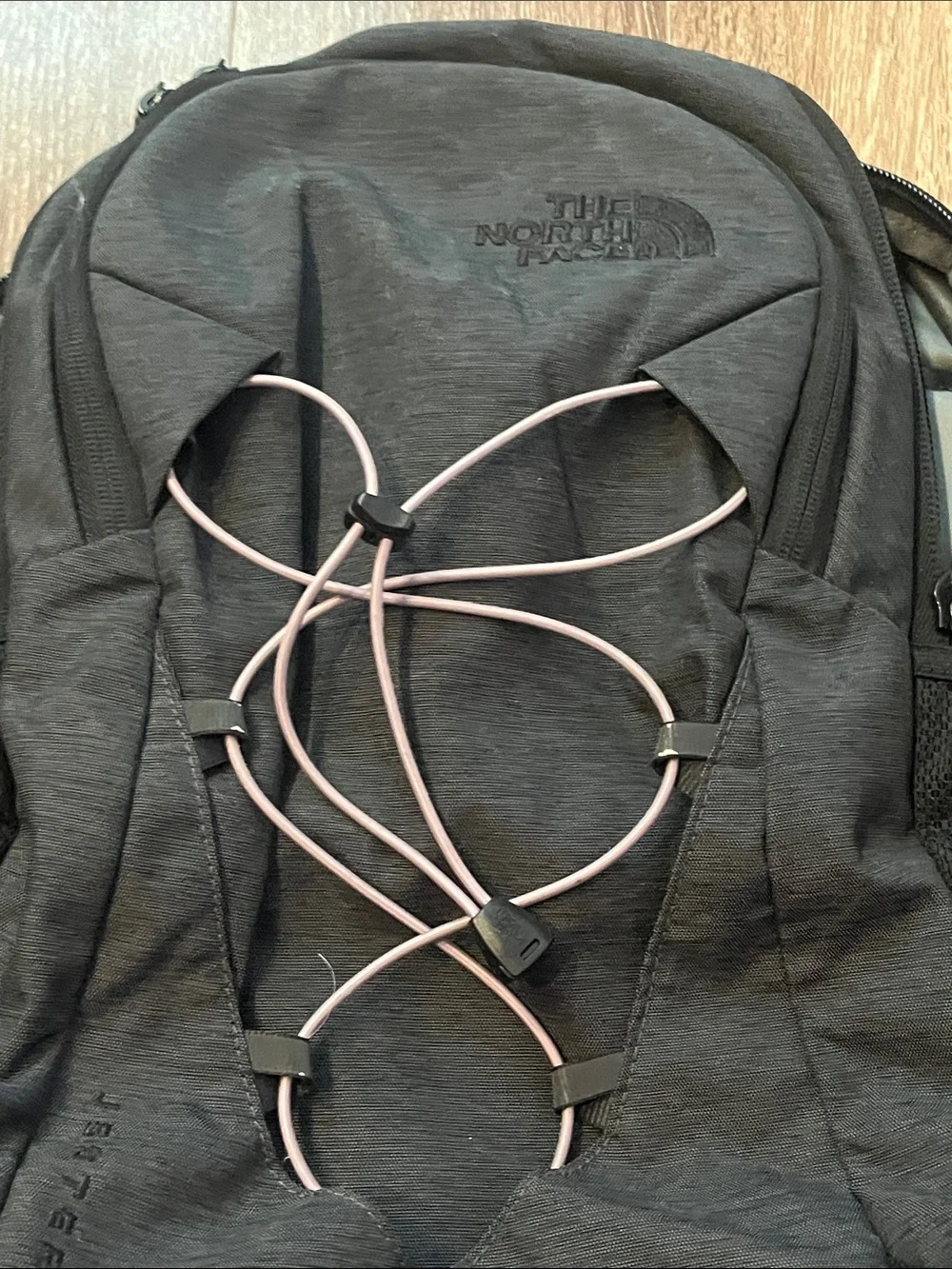 The NorthFace Jester Black Backpack with Light Pink Bungee Cord